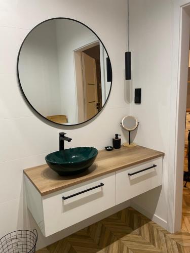 a bathroom with a sink and a mirror at Capital Towers RZESZOW, free parking, terrace in Rzeszów