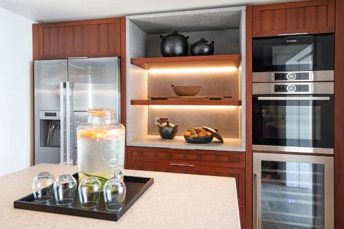 a kitchen with a refrigerator and a glass jar of liquid at Hotel Christopher Saint Barth in Gustavia