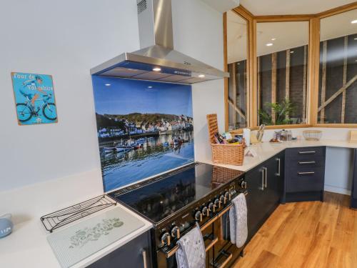 a kitchen with a stove with a picture of a harbor at Guisborough Town Hall in Guisborough
