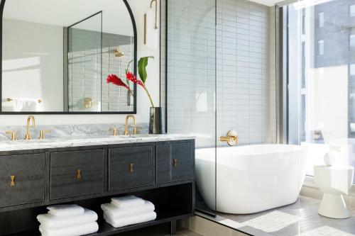 a bathroom with a tub and a sink at Kimpton Shane Atlanta by IHG in Atlanta