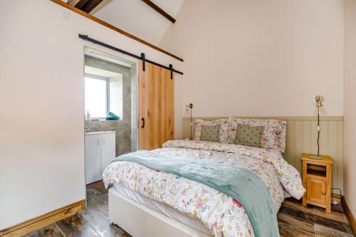 a bedroom with a bed and a window at Foxglove in Whitby
