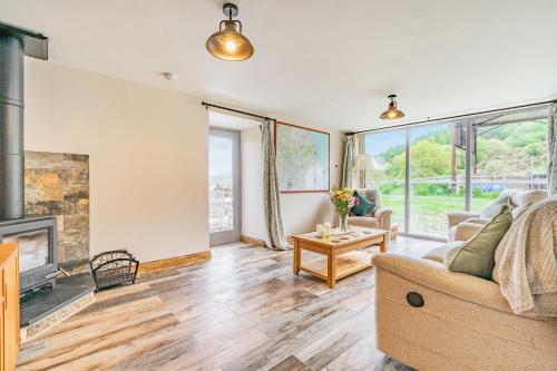 a living room with a couch and a fireplace at Meadowsweet in Whitby