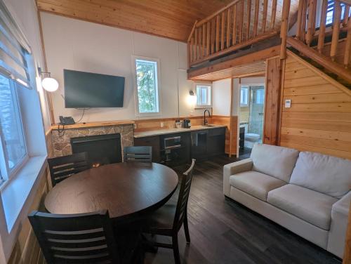 a living room with a table and a couch at Halcyon Hot Springs Resort in Halcyon Hot Springs