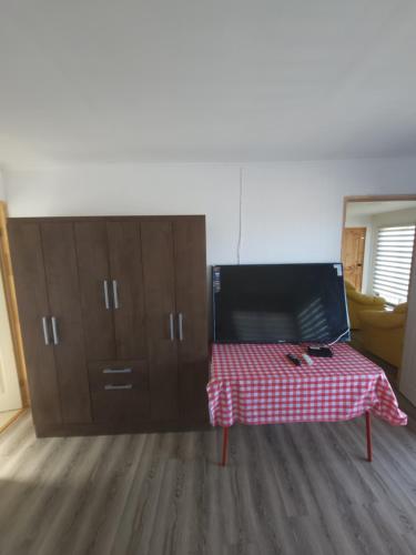 a room with a table with a red and white checkered table cloth at Casa amplia y acogedora in Guanaqueros
