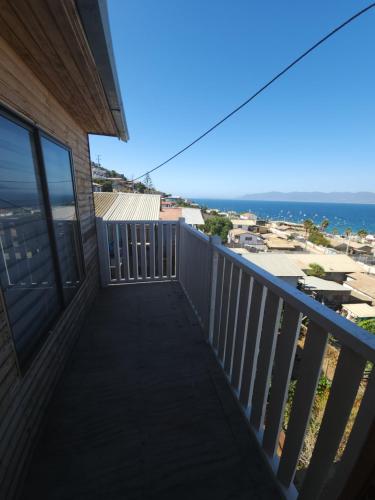 a balcony with a view of the ocean at Casa amplia y acogedora in Guanaqueros