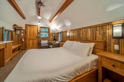 a large bed in a room with wooden walls at Halcyon Hot Springs Resort in Halcyon Hot Springs