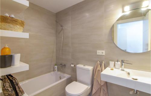a bathroom with a toilet and a sink and a tub at 3 Bedroom Cozy Apartment In Villajoyosa in Villajoyosa