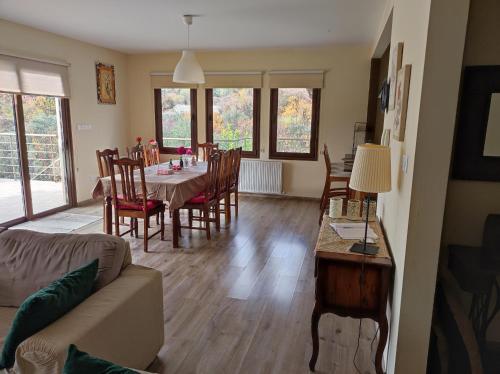 a living room with a dining room table and chairs at Roses Villa in Trimiklini