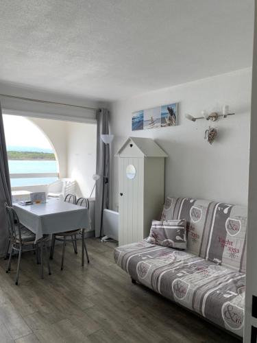 - une chambre avec un lit, une table, une table et des chaises dans l'établissement Superbe vue sur le chenal, à Leucate