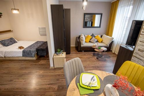 a living room with a bed and a couch at Studio Stankovic Royal Towers 326 in Bansko
