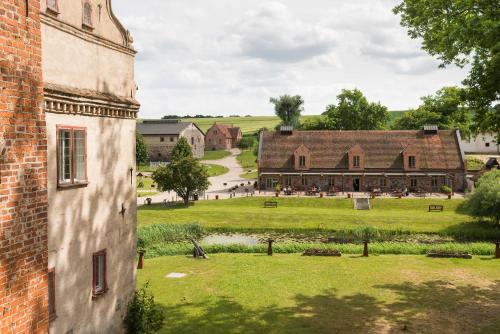 a view of a farm from a building at Hotel Schloss & Gut Ulrichshusen in Ulrichshusen