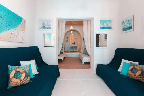 a living room with two blue couches at Huge villa Mykonos. Ideal for 8-12 guests in Mýkonos City