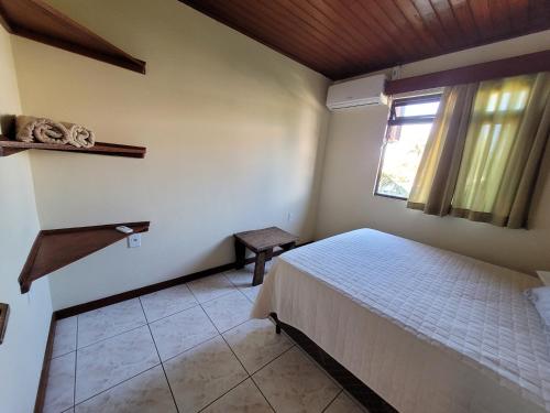 Katil atau katil-katil dalam bilik di Partiu Praia SC piscinas privativas, ar condicionado, internet, próximo ao mar e centrinho três minutos a pé