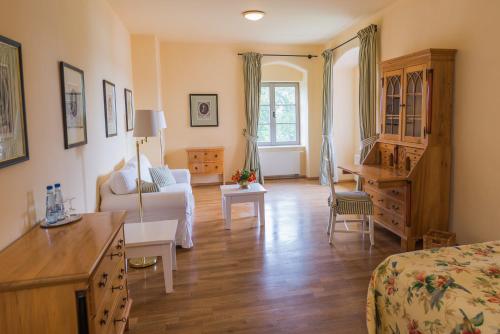 ein Schlafzimmer mit einem Bett und ein Wohnzimmer in der Unterkunft Hotel Schloss & Gut Ulrichshusen in Ulrichshusen