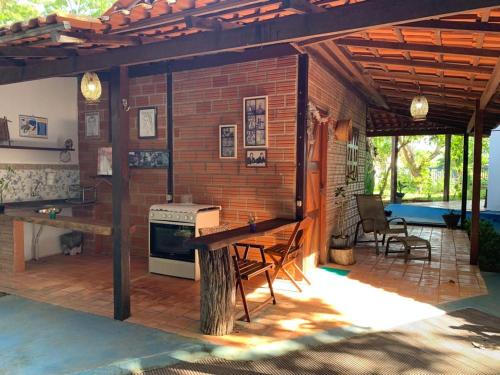 an outdoor kitchen with a brick wall and a stove at Cabana do Tapajós in Alter do Chao