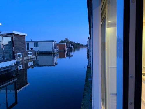 a view of a river from a window at Quiet Waterloft near Amsterdam and Schiphol WS17 in Aalsmeer