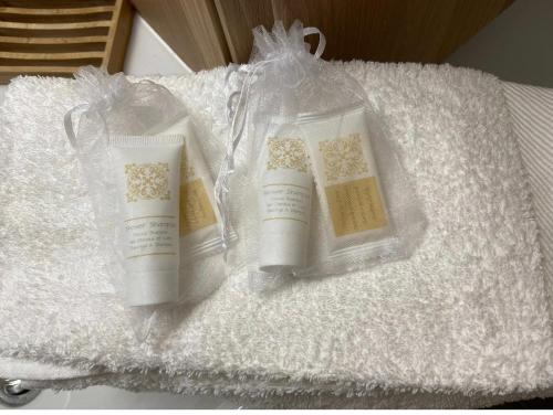 two bottles of soap sitting on a white towel at Residence Grand Roc - Kercham in Chamonix-Mont-Blanc