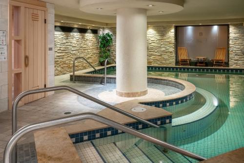 a swimming pool in a hotel lobby with a swimming pool at Banff Caribou Lodge and Spa in Banff