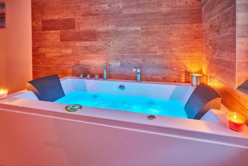 a bath tub in a room with a blue bath tub at Residence Ruth in Janske Lazne