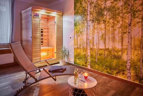 a room with a chair and a table and a window at Residence Ruth in Janske Lazne