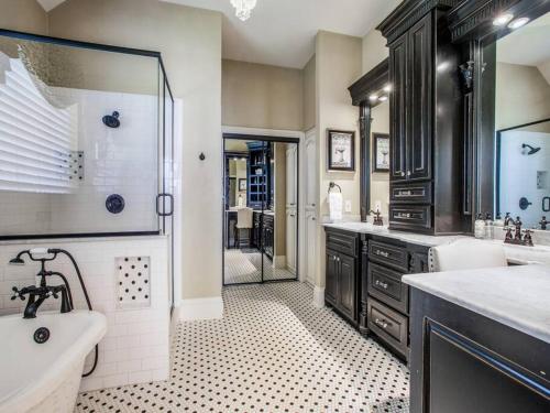 a bathroom with a tub and a sink and a shower at Executive home w/Study + pool near Lake in Rockwall