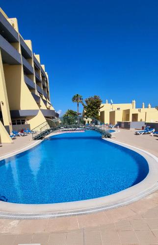 a large swimming pool in front of a building at Meia Praia Terrace in Lagos
