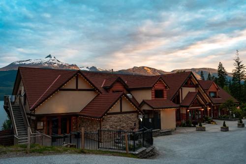 a large building with a mountain in the background at Halcyon Hot Springs Resort in Halcyon Hot Springs