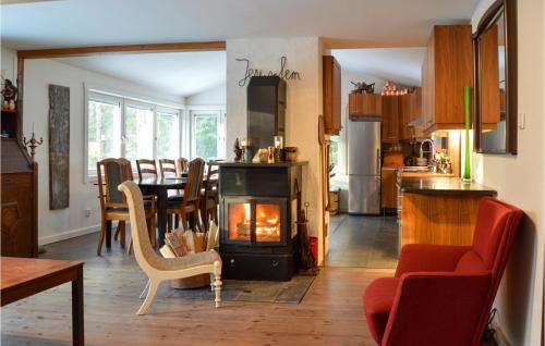 a kitchen and dining room with a stove in a room at Cozy Home In Strängnäs With Sauna in Strängnäs