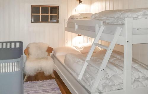 a bedroom with two bunk beds and a chair at Awesome Home In Fyresdal With Kitchen in Fyresdal