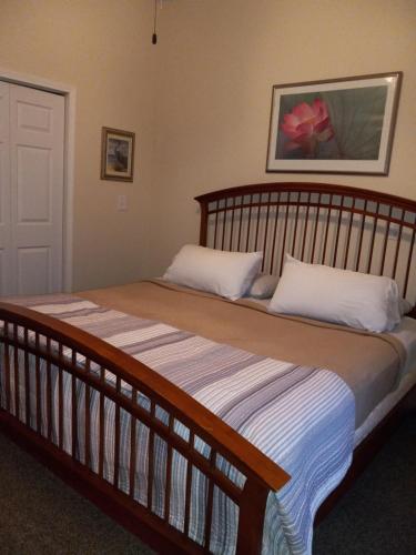 a bedroom with a large wooden bed with white pillows at The Barrel House Bed & Breakfast in Loretto