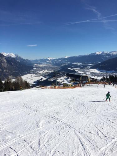 a person is skiing down a snow covered slope at Apartment Hohe Munde in Inzing