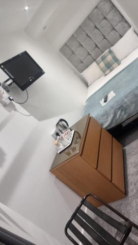 a room with a desk and a tv and a chair at Ocean Bay in Blackpool