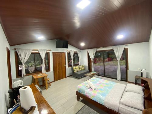 a living room with a bed and a couch at Chorotega Cabina in Monteverde Costa Rica