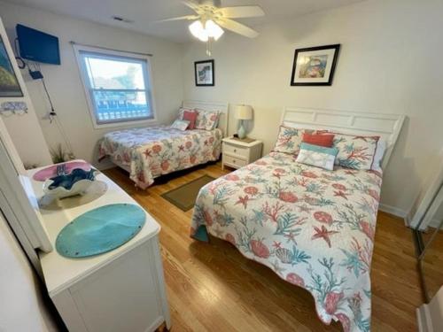 a bedroom with two beds and a ceiling fan at Boston Commons 101 Condo in Myrtle Beach