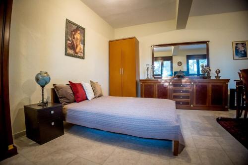 a bedroom with a bed and a dresser in it at Mountain house Lailias 