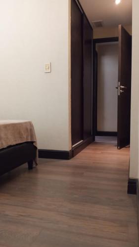 an empty room with a bed and a door at Quinta Manuela in Mendoza