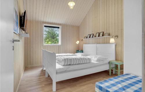 a bedroom with a white bed and a window at Cozy Home In Løgstør With Kitchen in Løgstør