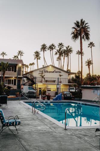 a resort with a swimming pool and palm trees at The Atwood Hotel San Diego - SeaWorld/Zoo in San Diego
