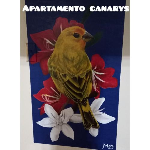 een gele vogel die bovenop bloemen zit bij Apartamento thecanarys in Santa Rosa de Cabal