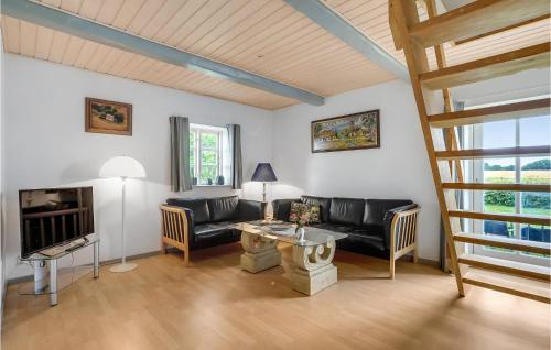 a living room with a couch and a table at Stunning Home In Bandholm With Kitchen in Bandholm