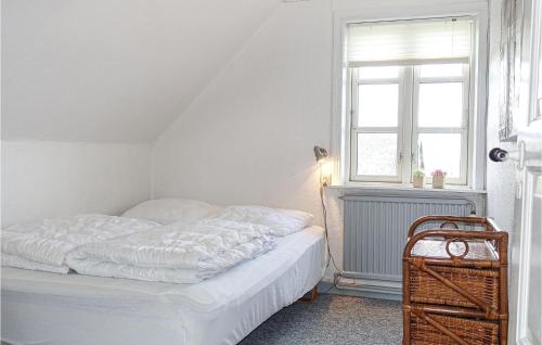 Cama blanca en habitación con ventana en Stunning Home In Gudhjem With Kitchen, en Gudhjem