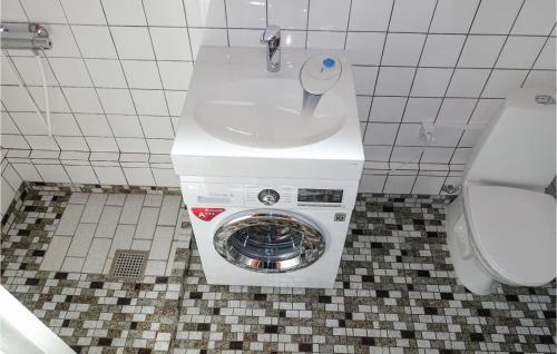 a washing machine in a bathroom with a toilet at Nice Apartment In Hasle With 2 Bedrooms And Wifi in Hasle