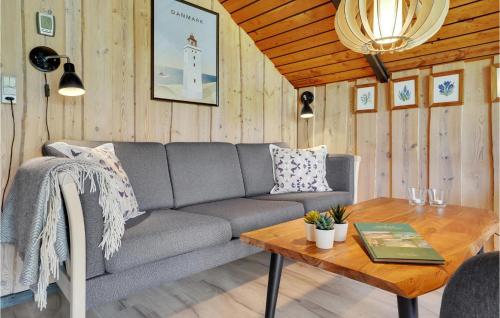 a living room with a couch and a table at 3 Bedroom Cozy Home In Fjerritslev in Fjerritslev
