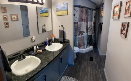 a bathroom with two sinks and a shower at Bear Doodle 2.0 in Sevierville