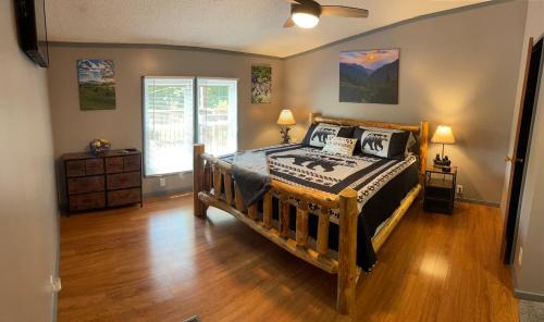 a bedroom with a wooden bed in a room at Bear Doodle 2.0 in Sevierville