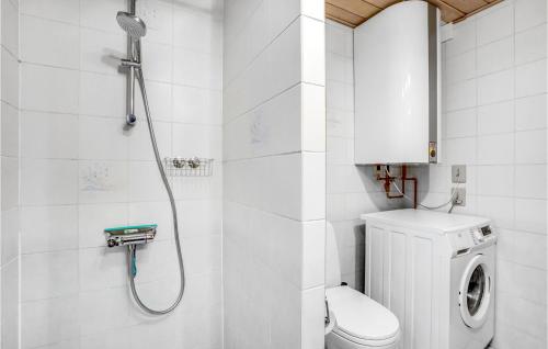 a bathroom with a toilet and a washing machine at Amazing Home In Nysted With Wifi in Nysted