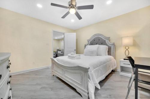 a bedroom with a white bed and a ceiling fan at Cozy 2 Bedroom Duplex In Charlotte, Jacuzzi, Sleeps 6 plus 2 in Charlotte