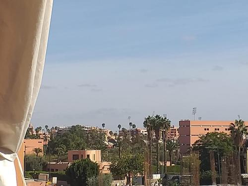 a view of a city with palm trees and buildings at Luxury apartment Gueliz (2 min walk from Train Station) in Marrakech
