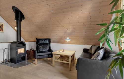 a living room with a couch and a wood stove at Beautiful Home In Gråsten With Wifi in Gråsten