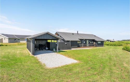 a house with a large yard in front of it at Amazing Home In Hjørring With Sauna in Hjørring